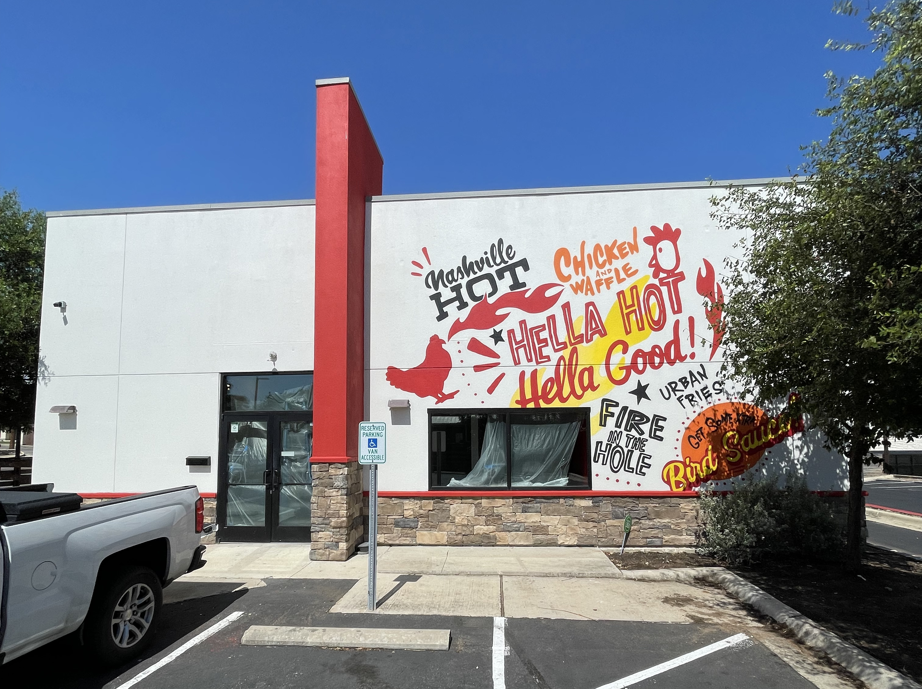 Exterior restaurant mural for Urban Bird Hot Chicken in San Marcos by an Austin muralist