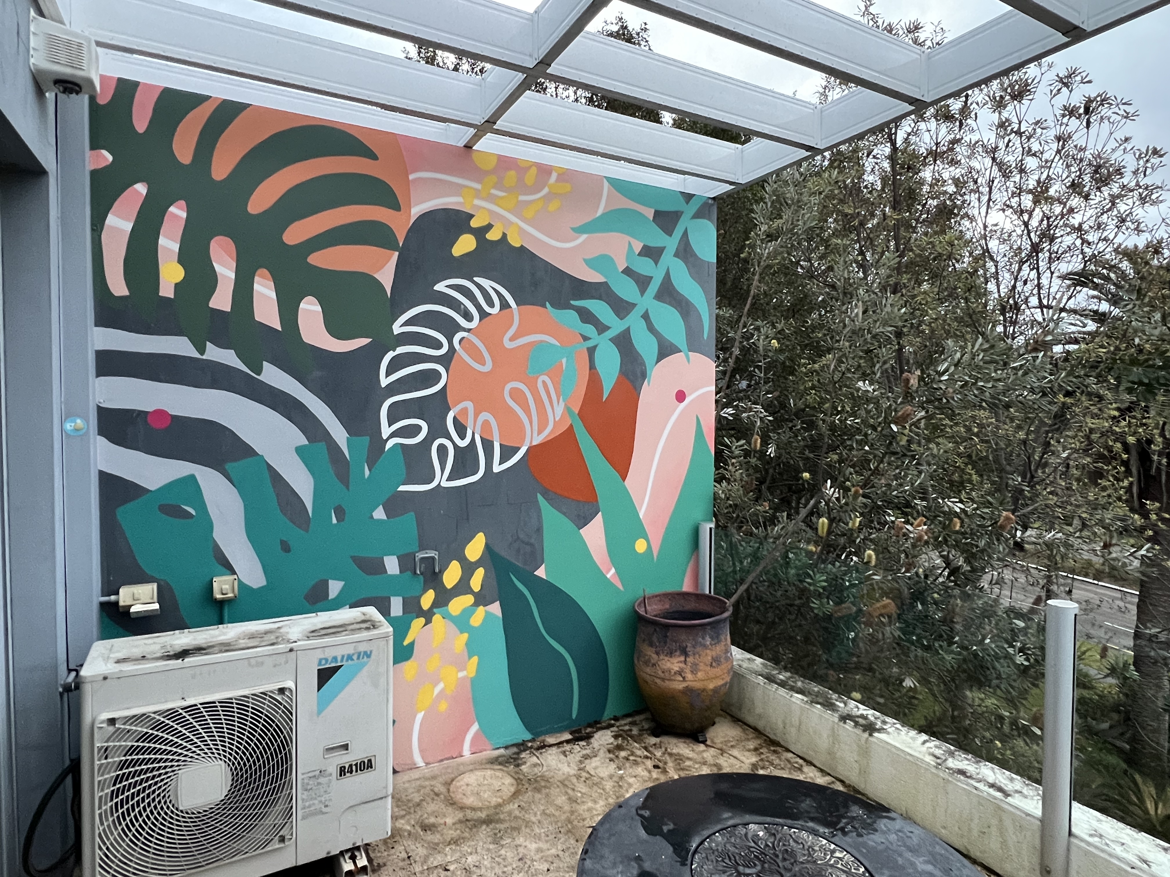 Native Australian foliage mural painted over a balcony wall and air-conditioning unit in Sutherland, Sydney
