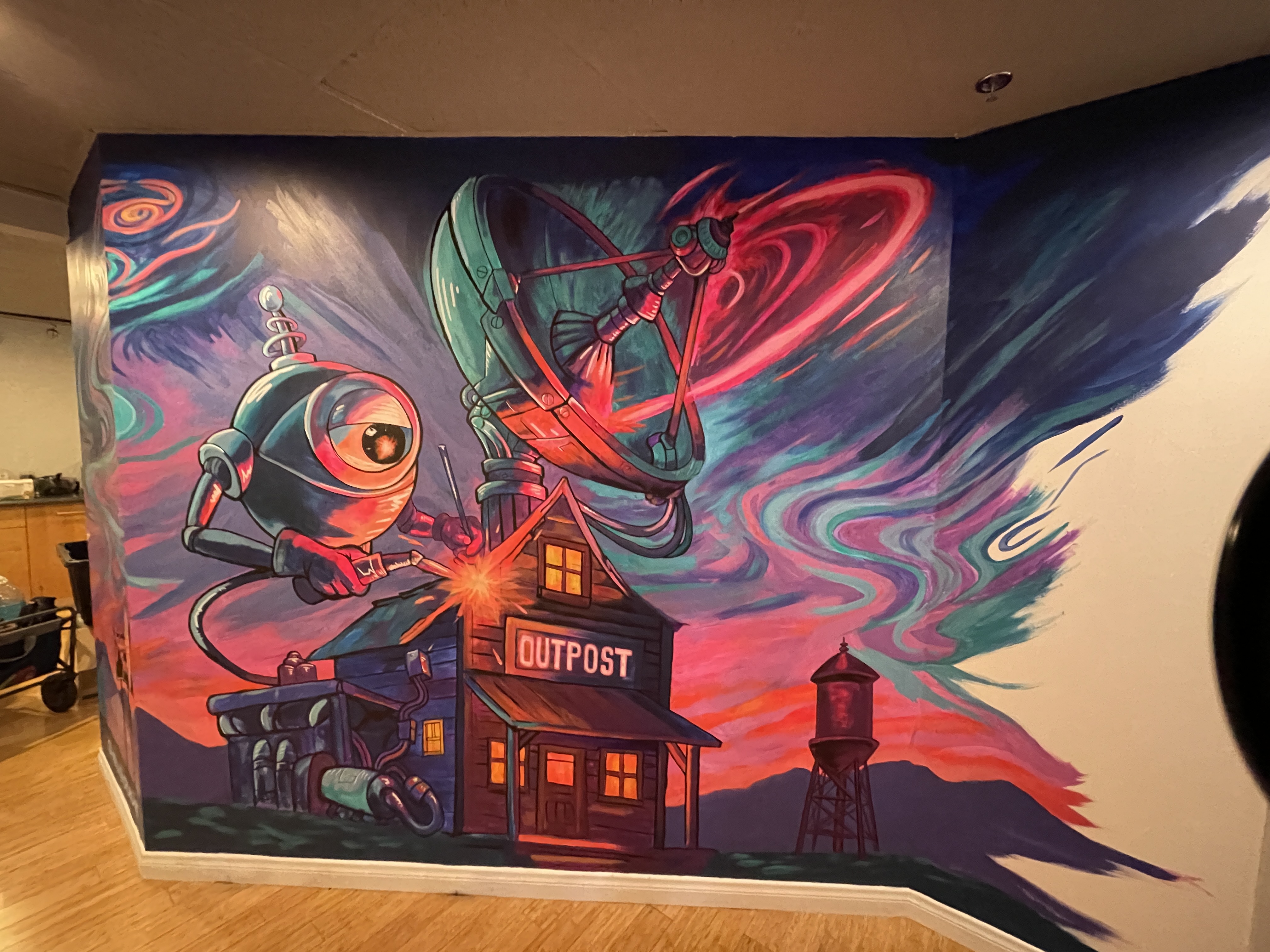 Robot mascot mural painted by a Burbank mural artist in a film marketing office