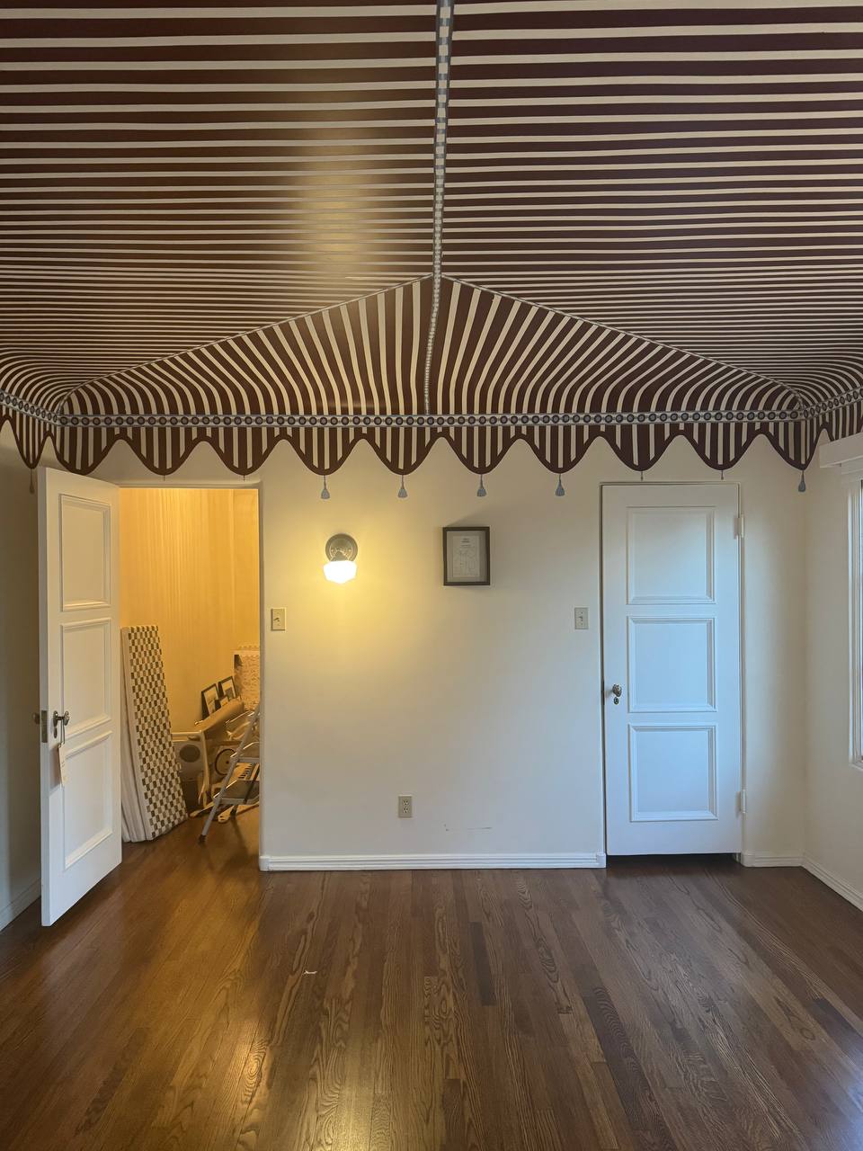 Playroom ceiling painted as a striped circus tent by a Los Angeles mural artist