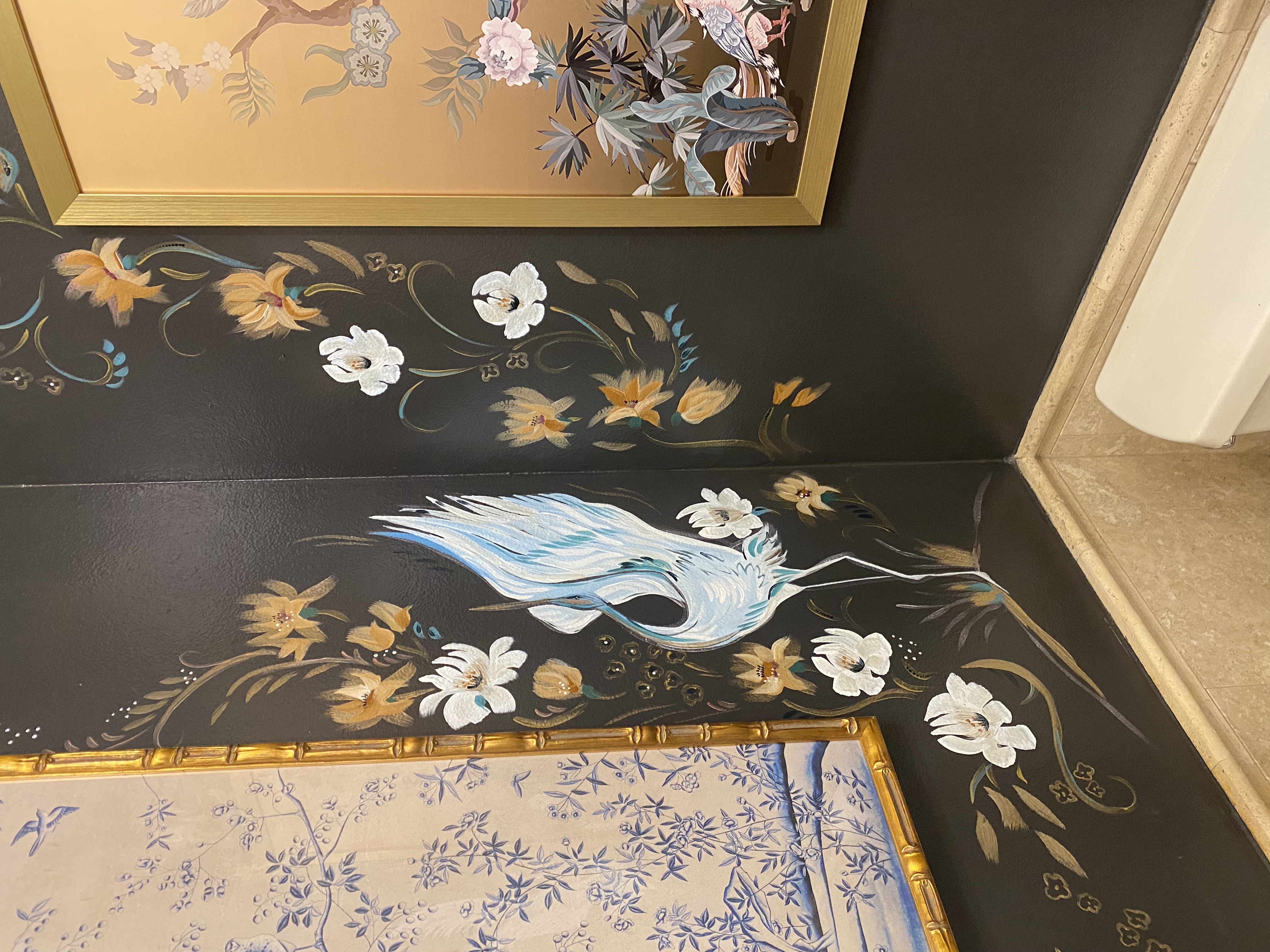 Hand-painted chinoiserie crane and magnolia border mural in a Los Angeles area powder room