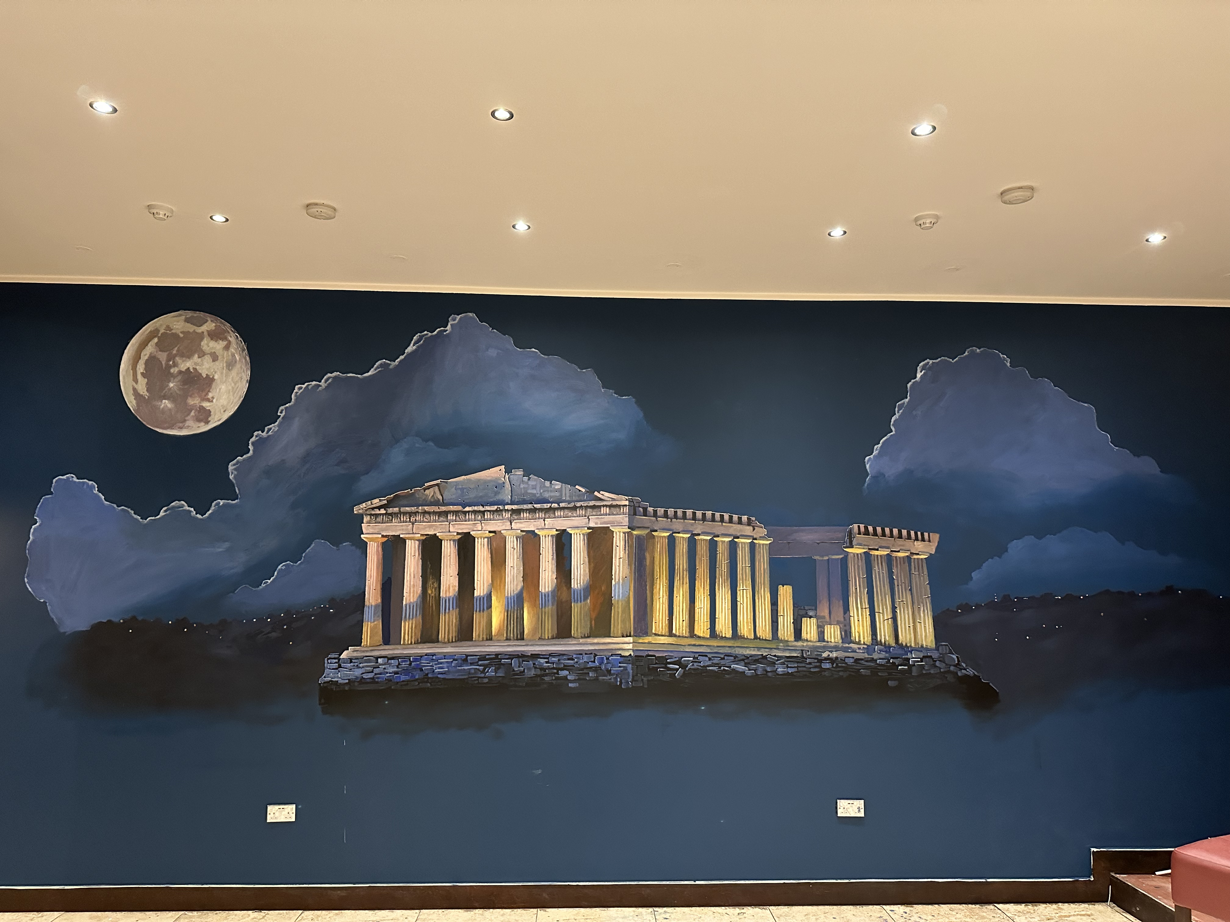 Moonlit mural of the Acropolis and Parthenon painted on an interior wall in London