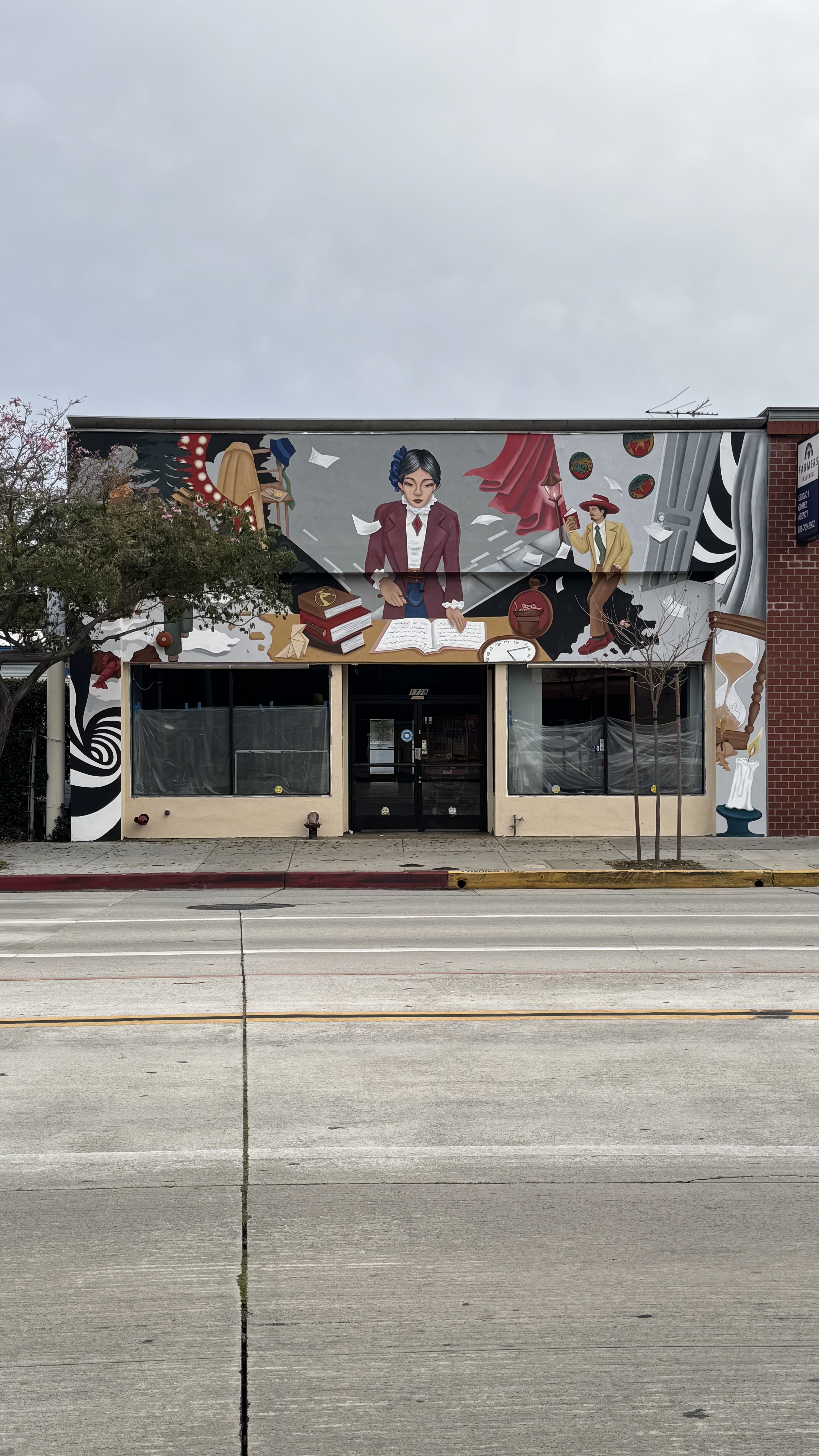 Art Deco noir storefront facade mural painted by a Pasadena muralist above a shop entrance