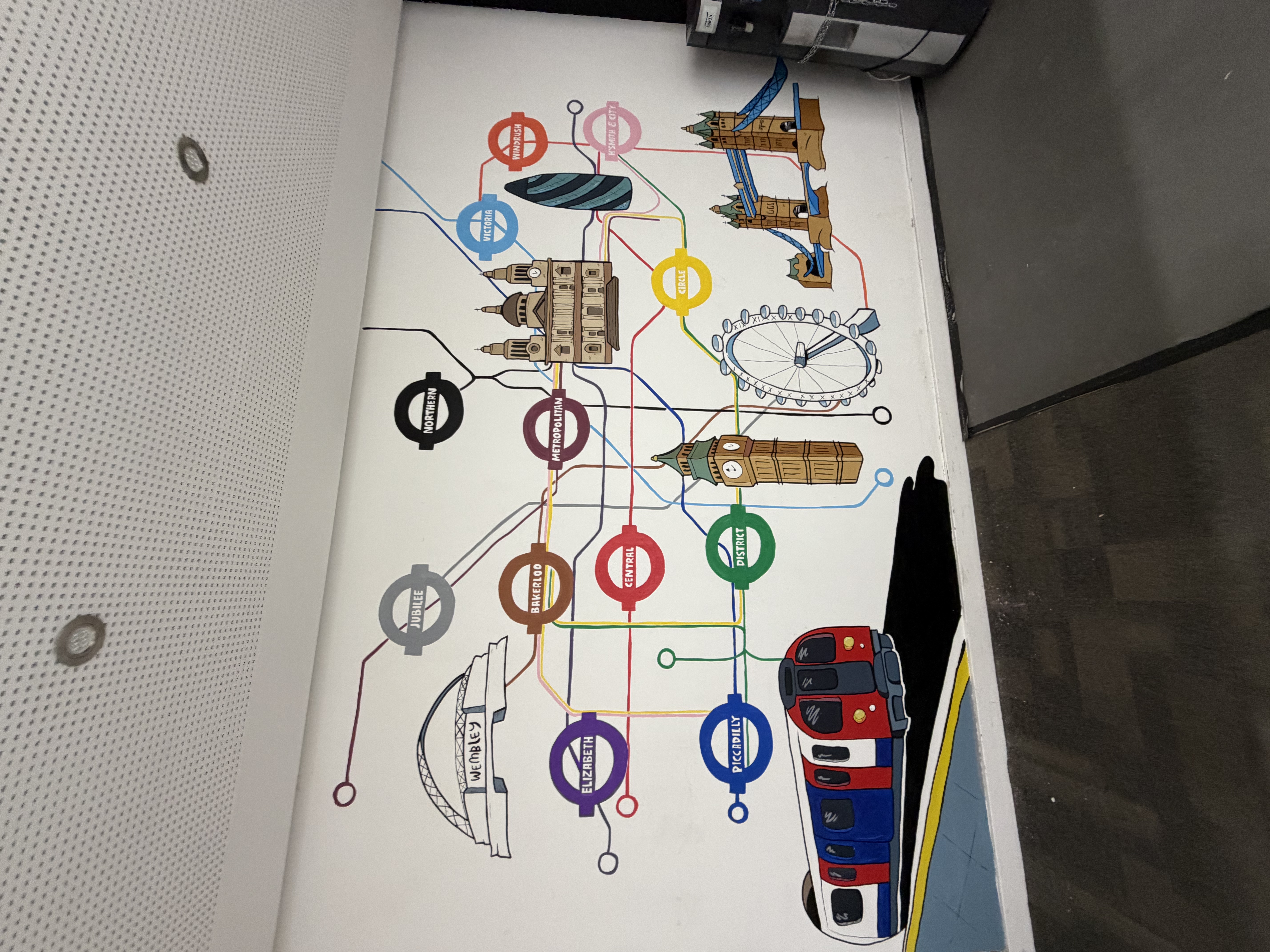 Colourful London Underground map mural painted along a school corridor wall