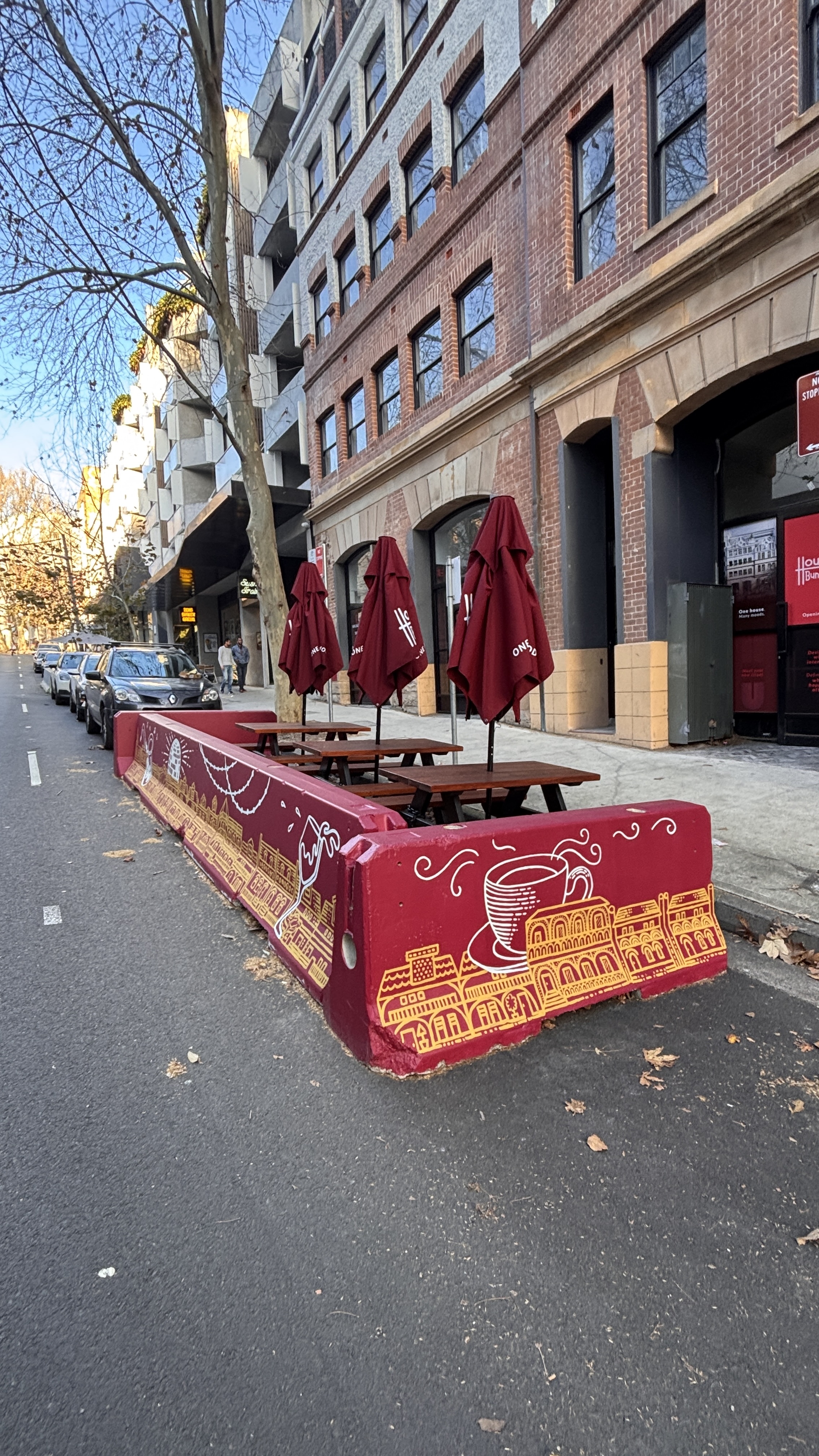 Painted concrete street barriers in Surry Hills, Sydney, decorated with gold line-drawn landmarks