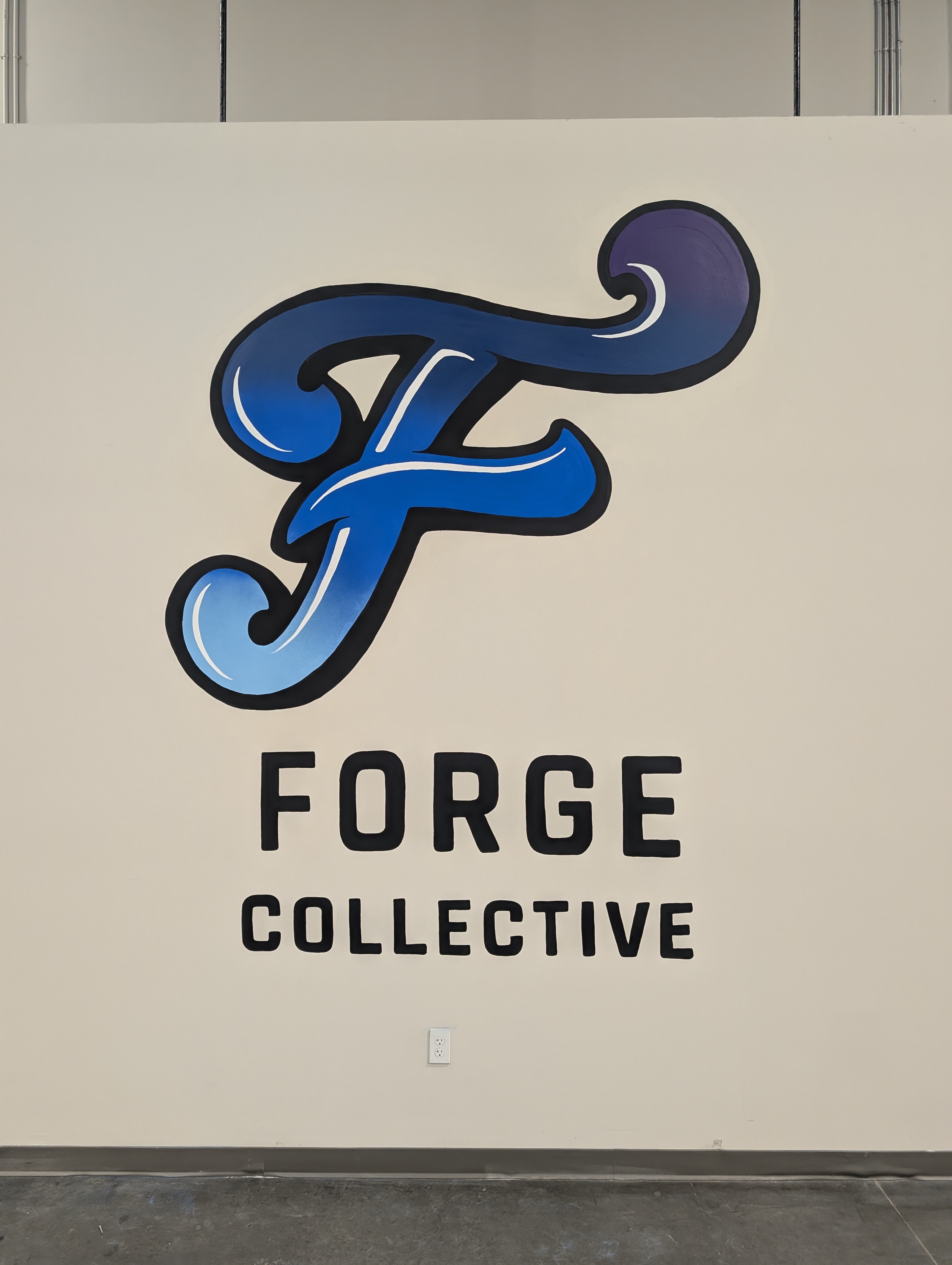 Hand-painted script logo mural at an El Monte sports complex near Los Angeles